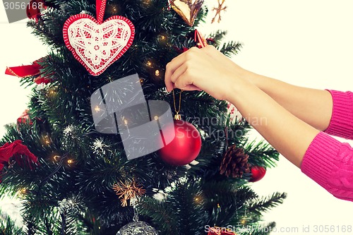 Image of close up of woman with christmas tree decoration