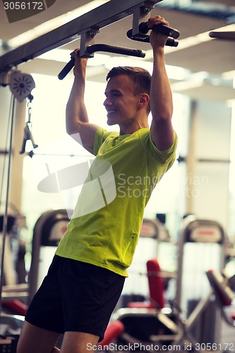 Image of smiling man exercising in gym