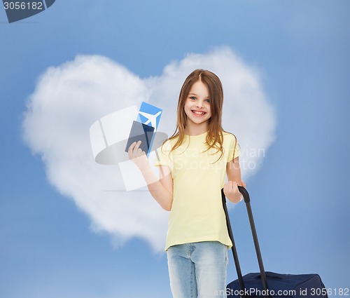 Image of smiling girl with travel bag ticket and passport