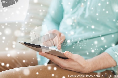 Image of close up of man with tablet pc computer at home