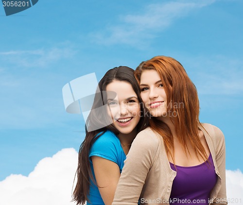 Image of smiling teenage girls hugging