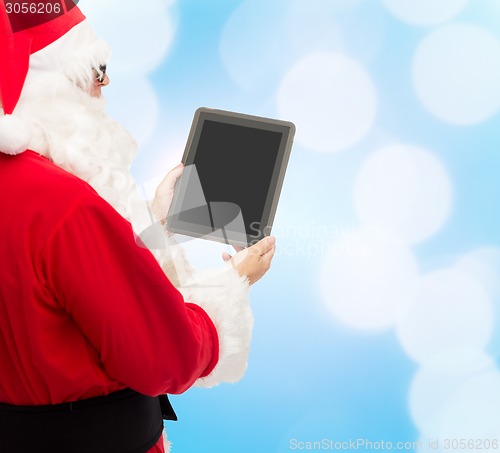 Image of man in costume of santa claus with tablet pc