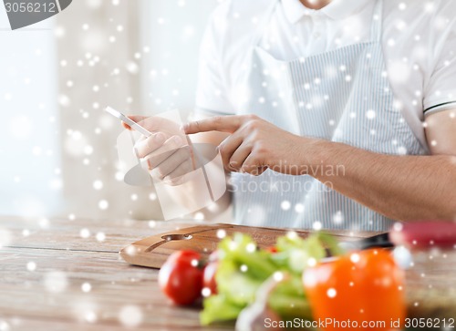Image of close up of man reading recipe from smartphone