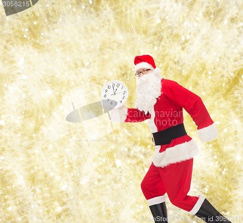 Image of man in costume of santa claus with clock