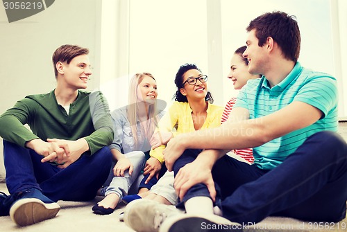 Image of five smiling teenagers having fun at home