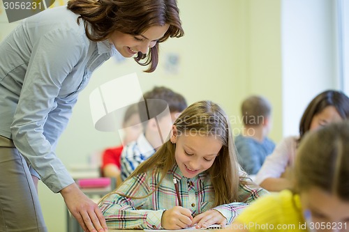 Image of group of school kids writing test in classroom