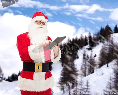Image of man in costume of santa claus with tablet pc