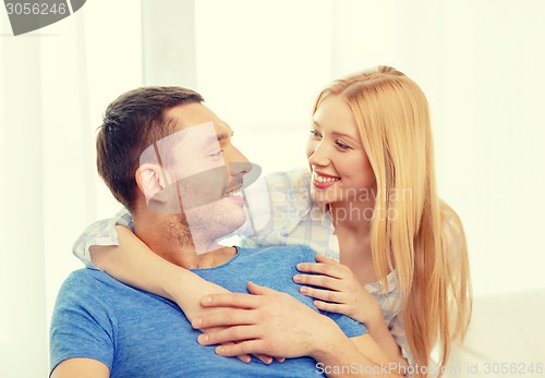 Image of smiling happy couple at home