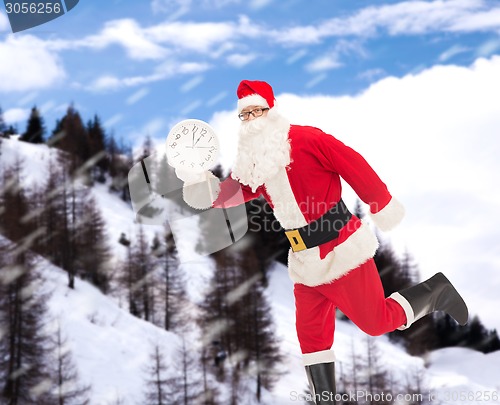 Image of man in costume of santa claus with clock