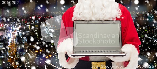 Image of close up of santa claus with laptop