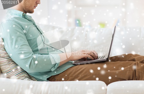 Image of close up of man working with laptop at home