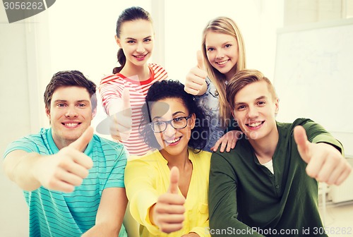 Image of smiling students at school showing thumbs up