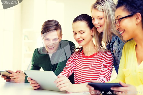 Image of smiling students with tablet pc at school