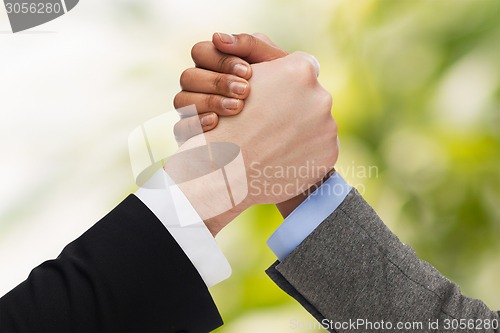 Image of hands of two people arm wrestling