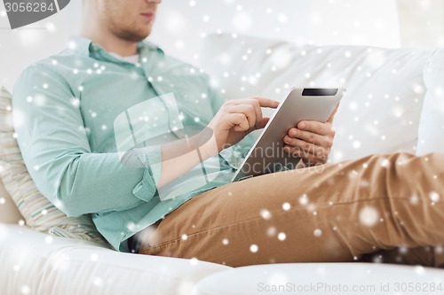 Image of close up of man with tablet pc computer at home