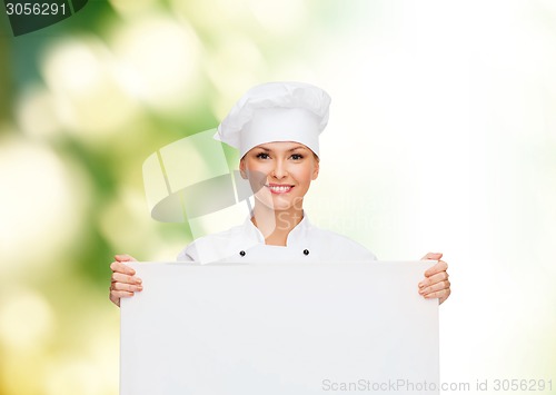 Image of smiling female chef with white blank board