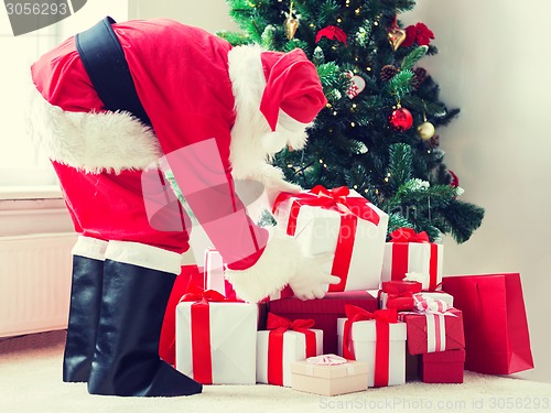 Image of man in costume of santa claus with presents
