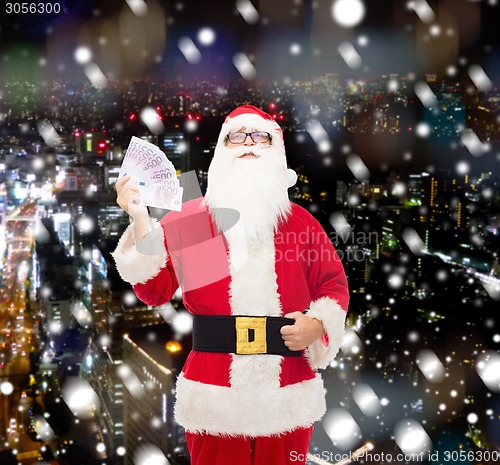 Image of man in costume of santa claus with euro money