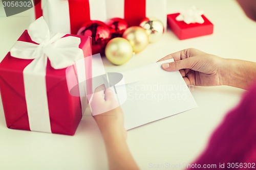 Image of close up of woman with letter and presents