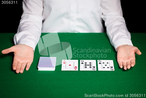 Image of holdem dealer with playing cards