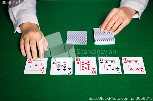 Image of holdem dealer with playing cards