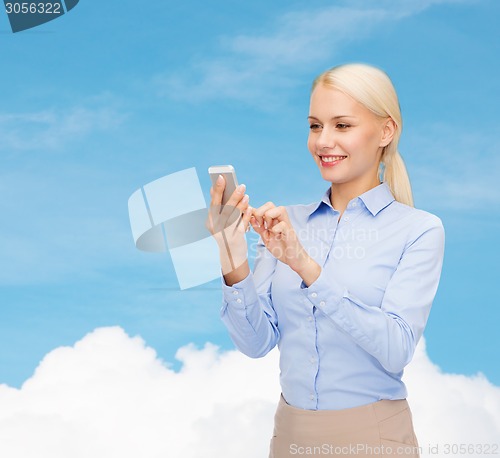 Image of young smiling businesswoman with smartphone