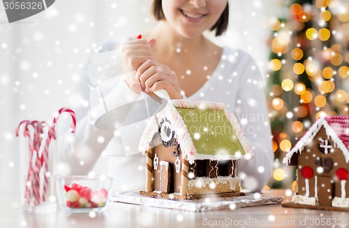 Image of close up of woman making gingerbread houses