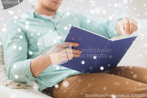 Image of close up of man reading book at home