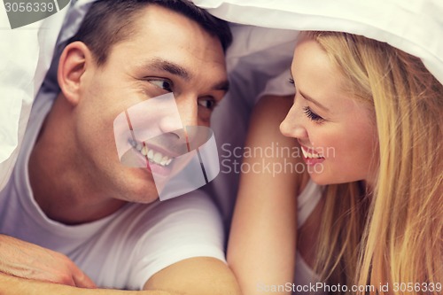 Image of happy couple sleeping in bed