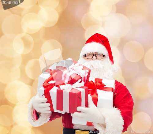 Image of man in costume of santa claus with gift boxes