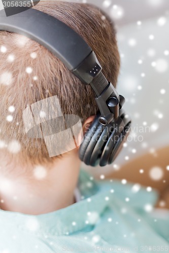 Image of close up of man in headphones at home