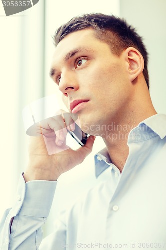 Image of serious businessman with smartphone