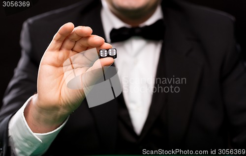 Image of close up of man showing dice with double six