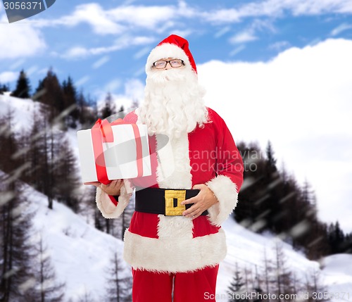 Image of man in costume of santa claus with gift box