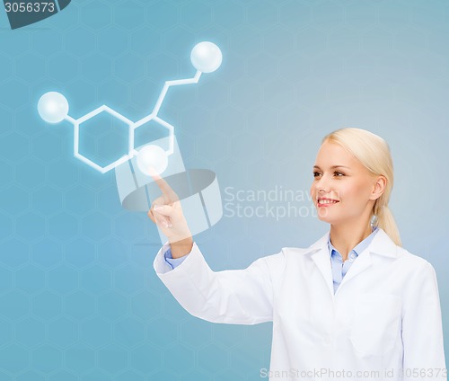 Image of smiling female doctor pointing to molecule