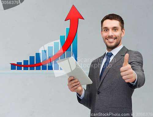 Image of businessman with tablet pc showing thumbs up