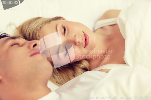 Image of happy couple sleeping in bed