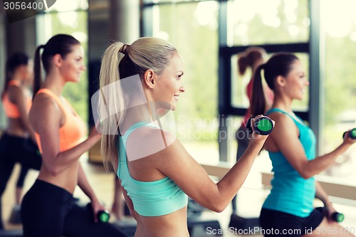 Image of group of women with dumbbells and steppers