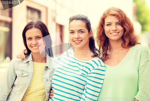 Image of smiling teenage girls with on street