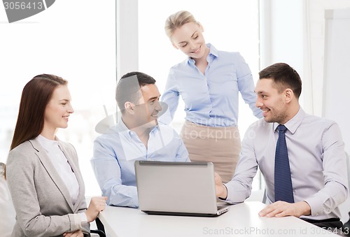 Image of business team working with laptop in office