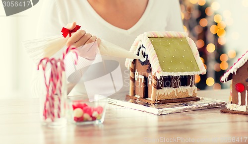 Image of close up of woman making gingerbread houses