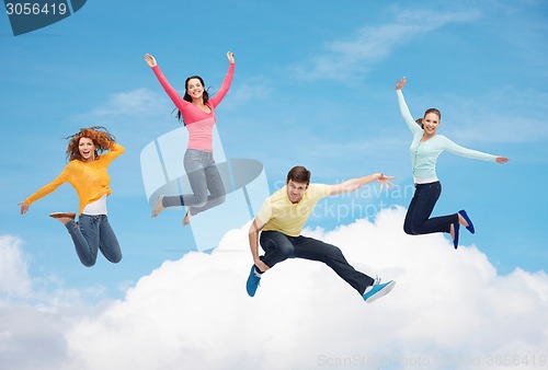 Image of group of smiling teenagers jumping in air