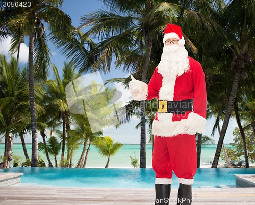 Image of man in costume of santa claus showing thumbs up