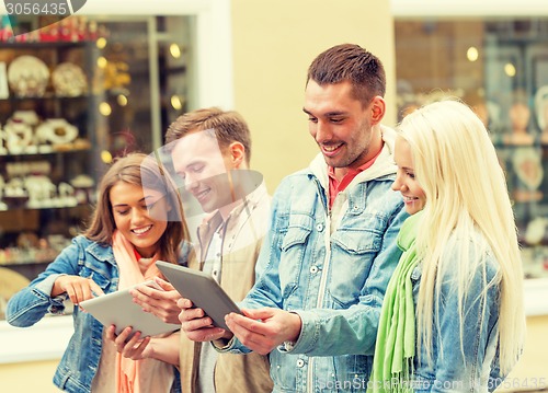 Image of group of smiling friends with tablet pc computers