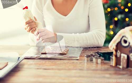 Image of close up of woman making gingerbread houses