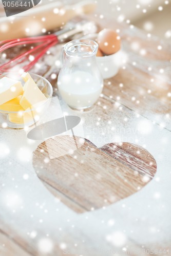 Image of  heart of flour on wooden table at home