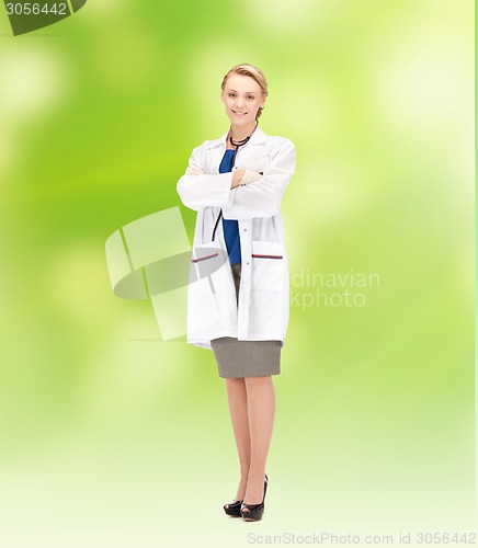 Image of smiling young female doctor in white coat