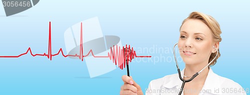 Image of smiling female doctor listening to heartbeat