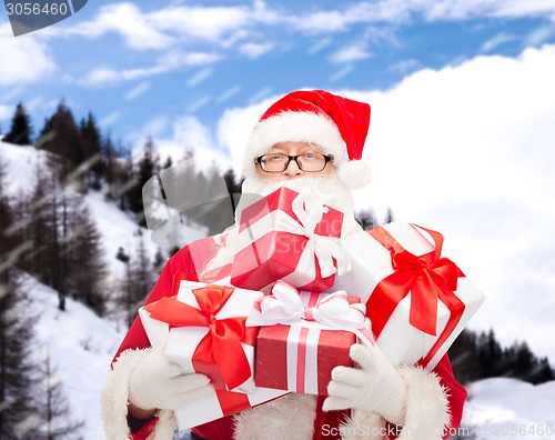 Image of man in costume of santa claus with gift boxes