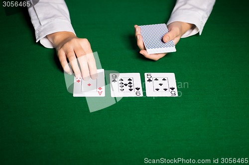 Image of holdem dealer with playing cards